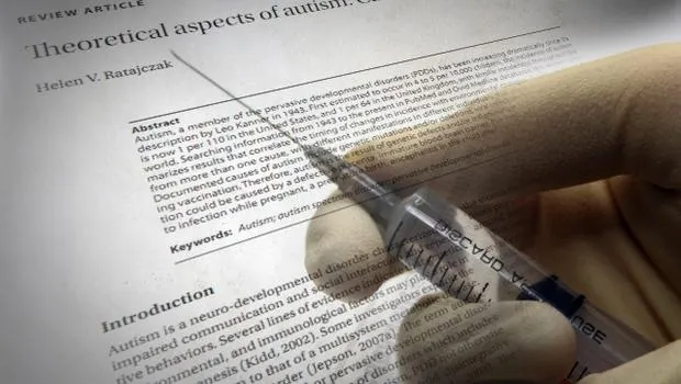 An Examination of Autism Theories Syringe poised over a medical article discussing the theoretical aspects of autism and vaccination